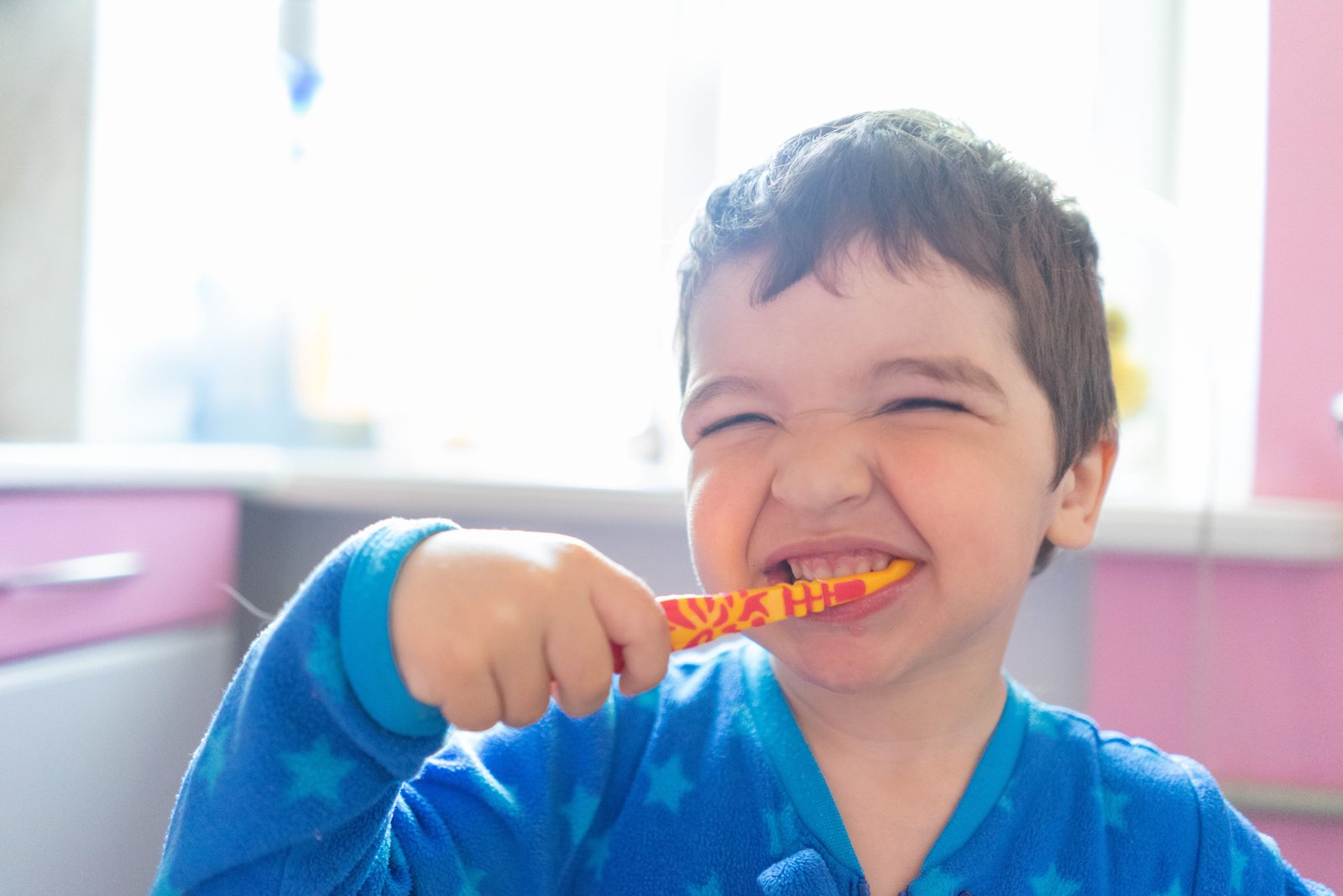 Parent teaching child brushing techniques